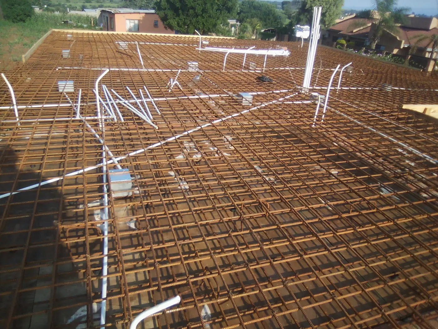 Conduit and boxes laid out across reinforced slab mesh